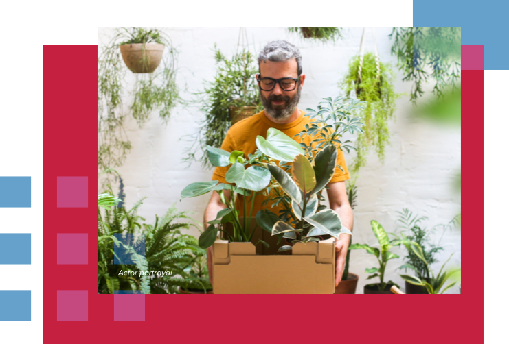 Individual holding cardboard box with new plants for his terrace. Actor portrayal.